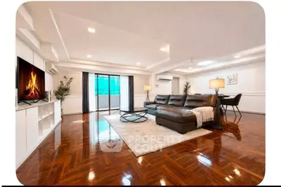 Spacious living room with elegant wooden flooring and modern decor, featuring a cozy fireplace and large windows.