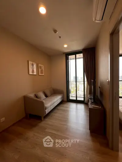 Cozy living room with modern decor and city view balcony access