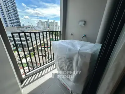 Modern balcony with city view and washing machine in urban apartment