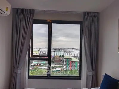 Modern bedroom with large window offering a stunning city view, featuring elegant curtains and air conditioning.