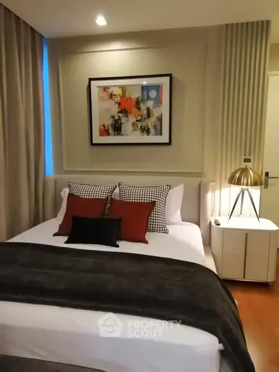 Cozy bedroom with modern decor and stylish lighting in a contemporary apartment.