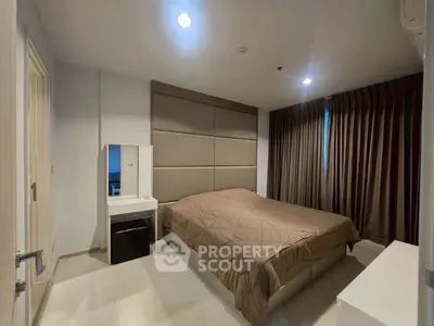 Spacious modern bedroom with elegant decor and natural lighting