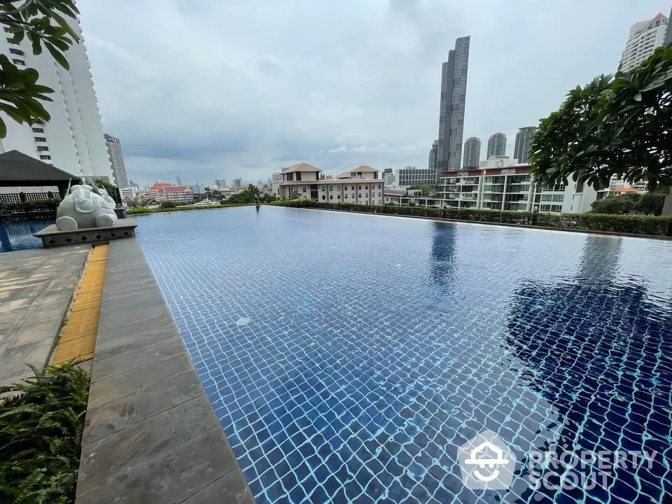 Stunning rooftop pool with city skyline views in luxury apartment complex.