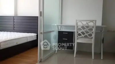 Modern bedroom with sleek furniture and study area