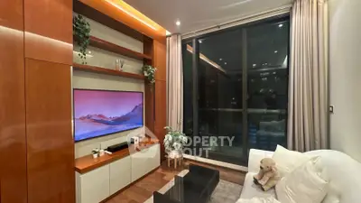 Luxurious living room with modern entertainment center and large window view.