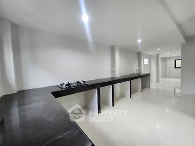 Spacious modern kitchen with sleek countertops and gas stove