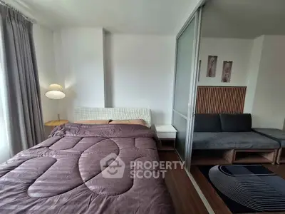Modern bedroom with cozy bed and stylish decor in a contemporary apartment.
