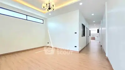 Spacious modern living room with elegant chandelier and wooden flooring