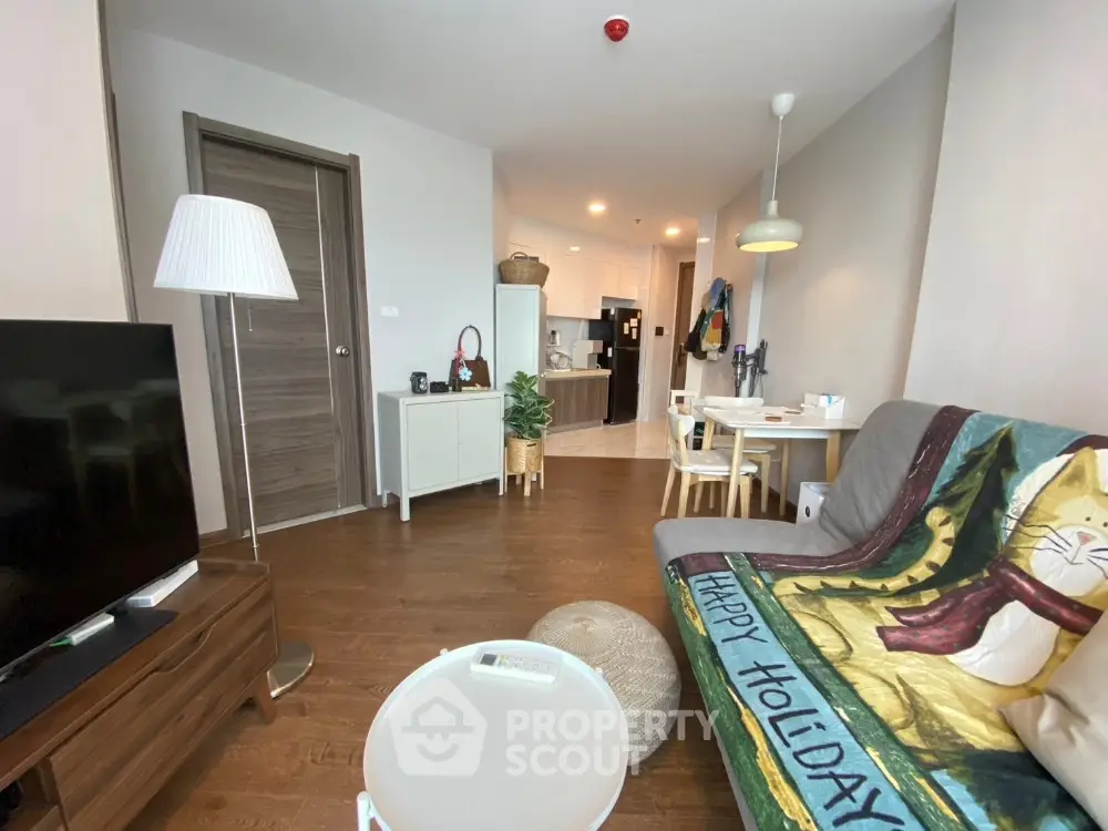 Modern living room with cozy decor and open kitchen layout in a stylish apartment