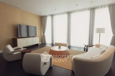 Elegant living room with modern furniture and large windows, perfect for relaxation and entertainment.