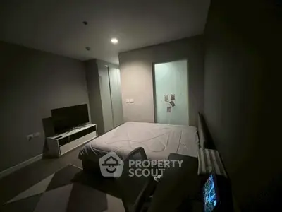 Cozy bedroom with modern decor and ambient lighting, featuring a comfortable bed and sleek furniture.