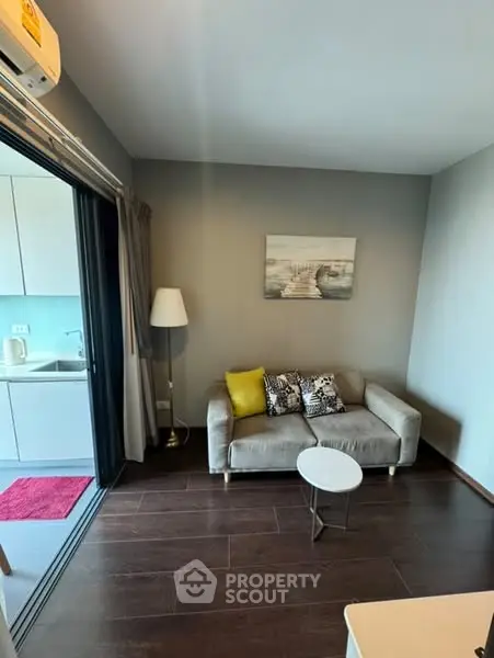 Modern living room with cozy sofa and open kitchen layout