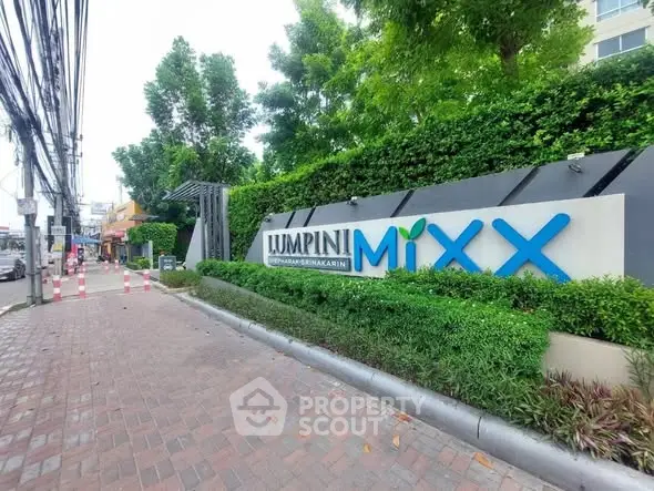 Lush entrance of Lumpini Mixx with modern signage and greenery.