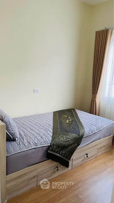 Cozy bedroom with single bed and elegant decor, perfect for a serene living experience.