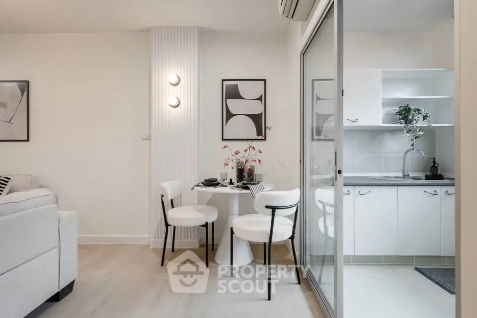Modern open-plan living room and kitchen with stylish decor and natural light.