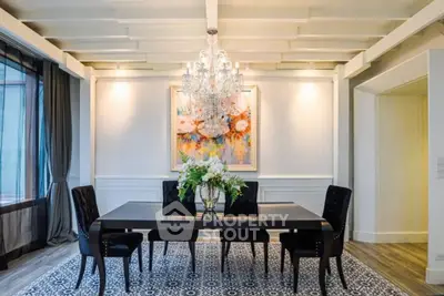 Elegant dining room with chandelier, modern decor, and stylish furniture