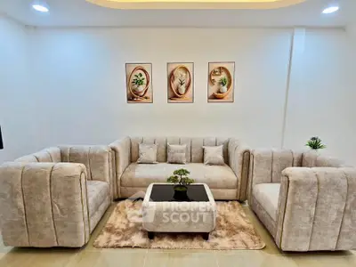 Elegant living room with plush beige sofas and modern decor