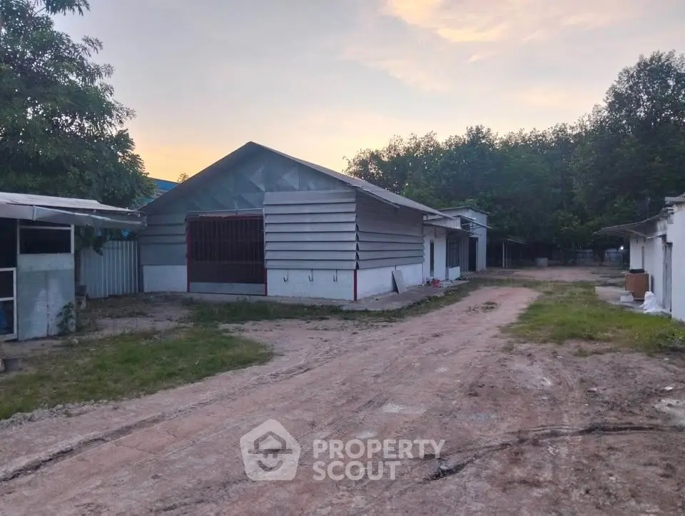 Spacious rural property with multiple buildings and natural surroundings, ideal for development or agricultural use.