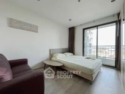 Bright bedroom with balcony view and modern furnishings