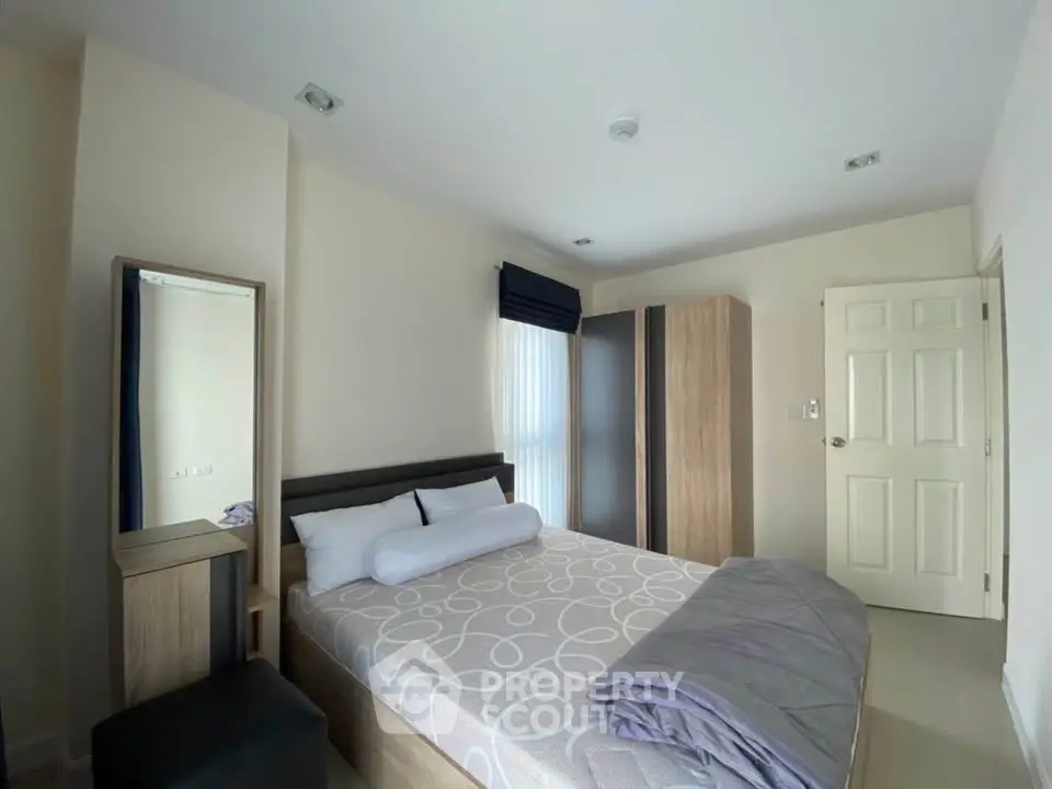 Cozy bedroom with modern furnishings and ample natural light