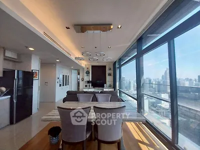 Luxurious modern living room with panoramic city view and elegant dining area