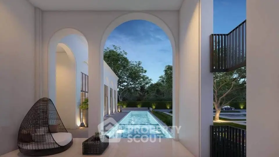 Luxurious modern villa with elegant pool and serene garden view at dusk.