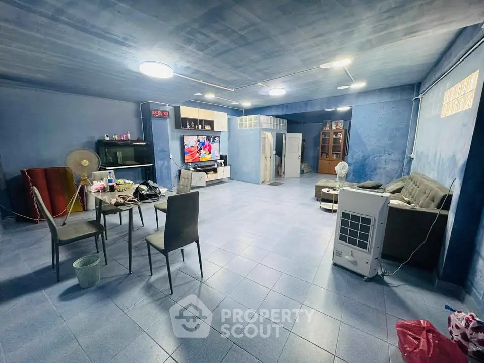 Spacious living room with modern decor and entertainment setup, perfect for relaxation and gatherings.