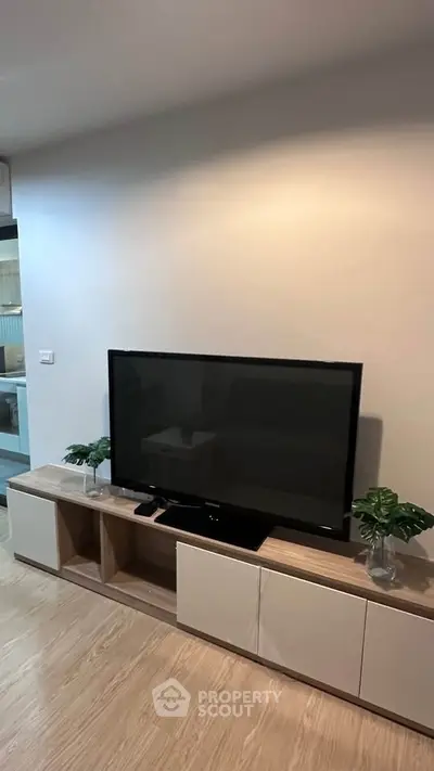 Modern living room with sleek TV stand and minimalist decor, perfect for contemporary living.