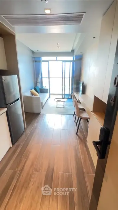 Modern open-plan living room with stylish decor and large windows for natural light.