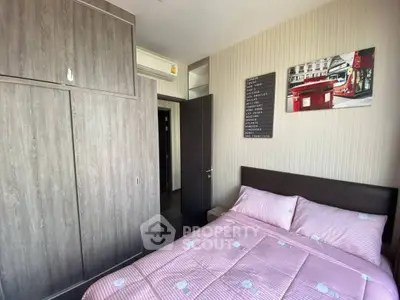 Cozy bedroom with modern wardrobe and stylish decor in a well-lit apartment.
