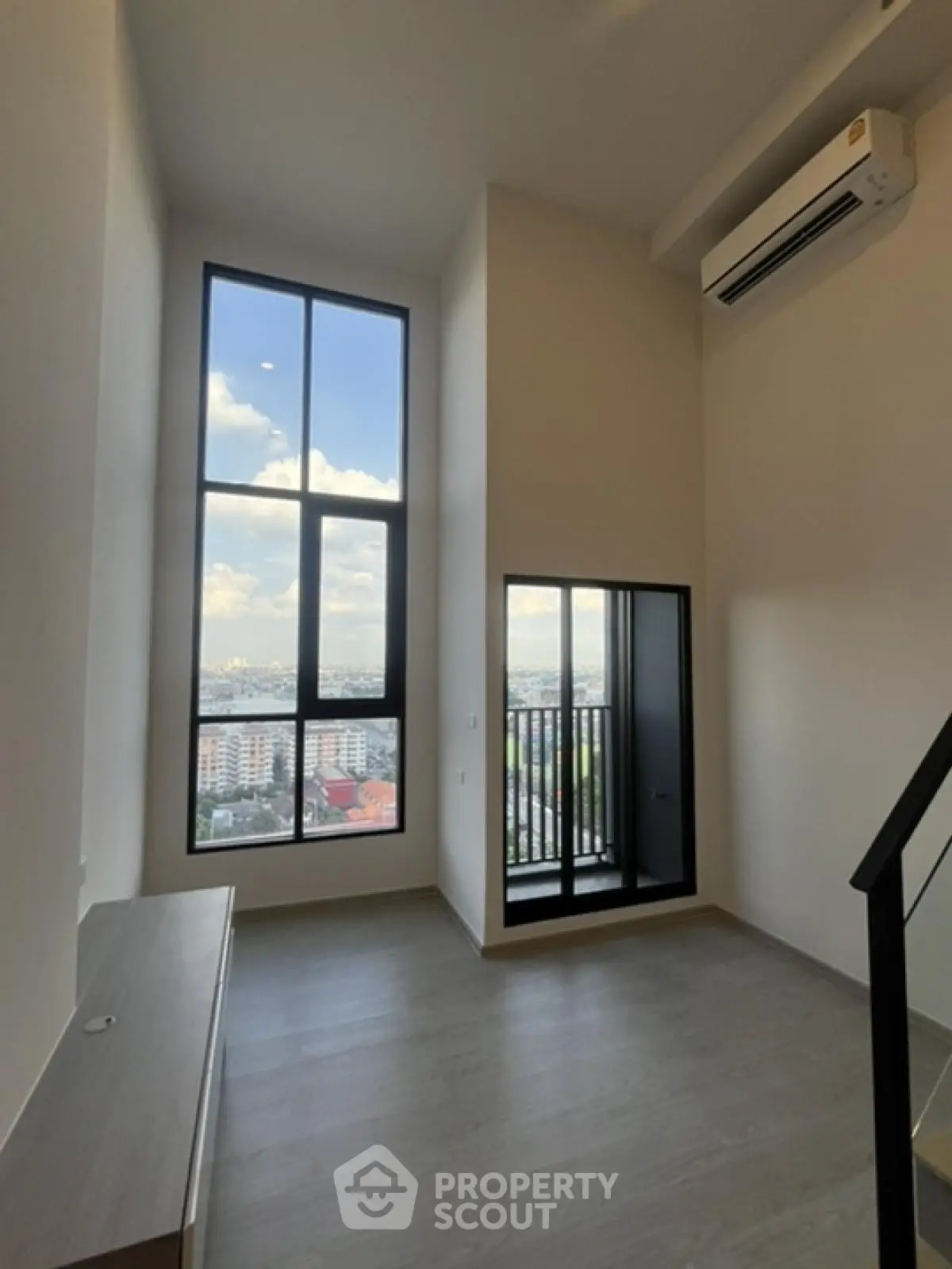 Modern high-rise apartment with floor-to-ceiling windows and balcony view