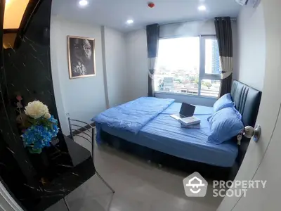 Modern bedroom with city view, featuring a cozy bed and stylish decor in a high-rise apartment.