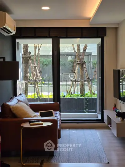 Cozy living room with leather sofa and garden view through large window