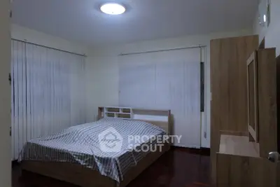 Cozy bedroom with wooden furniture and soft lighting