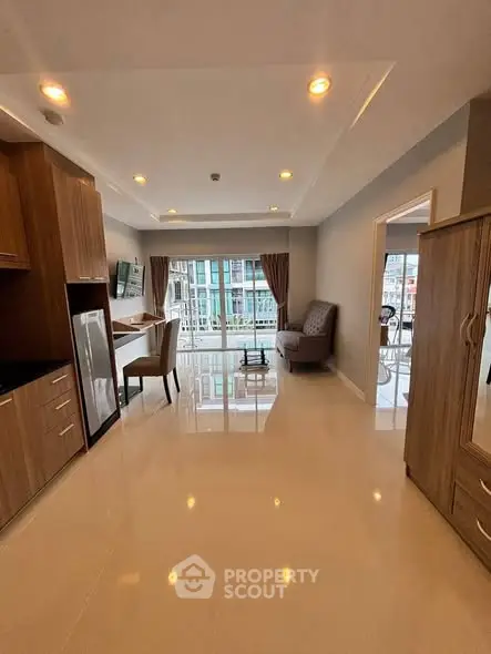 Spacious modern living room with elegant furnishings and city view.