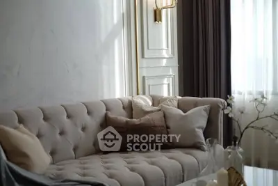 Elegant living room with plush sofa and soft lighting, perfect for relaxation.