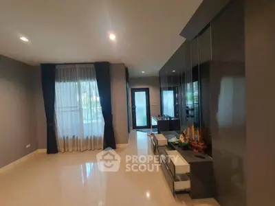 Spacious modern living room with sleek decor and large windows for natural light.