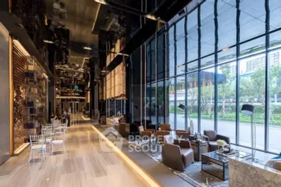 Luxurious modern building lobby with elegant seating and floor-to-ceiling windows offering garden views.