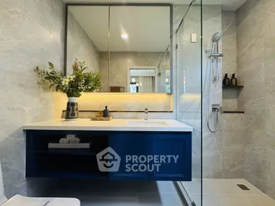 Modern bathroom with elegant vanity and glass shower enclosure