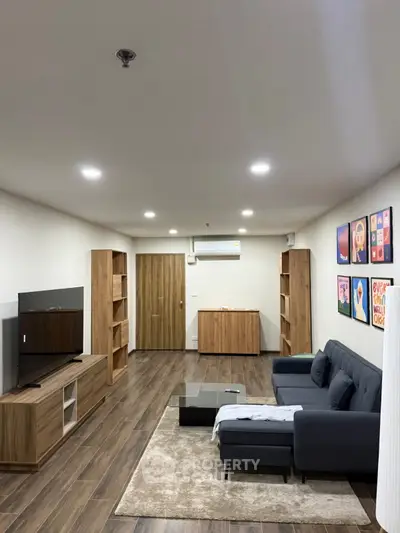 Spacious modern living room with stylish furniture and wooden flooring