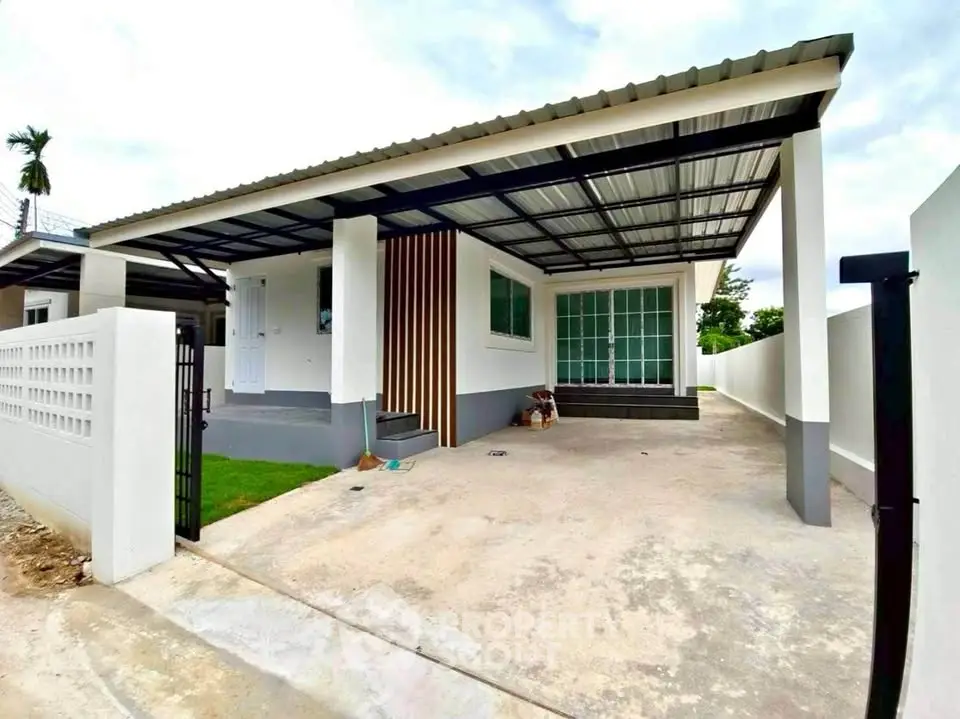 Modern single-story home with covered carport and sleek design.