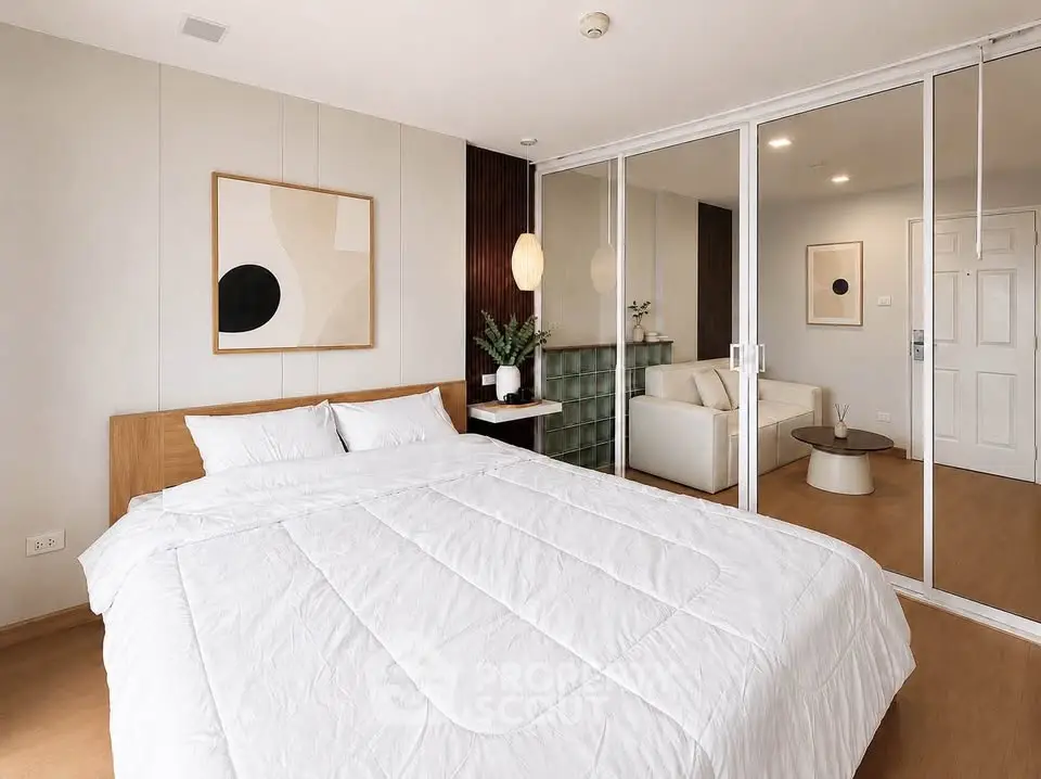 Modern bedroom with sliding glass doors and cozy living area
