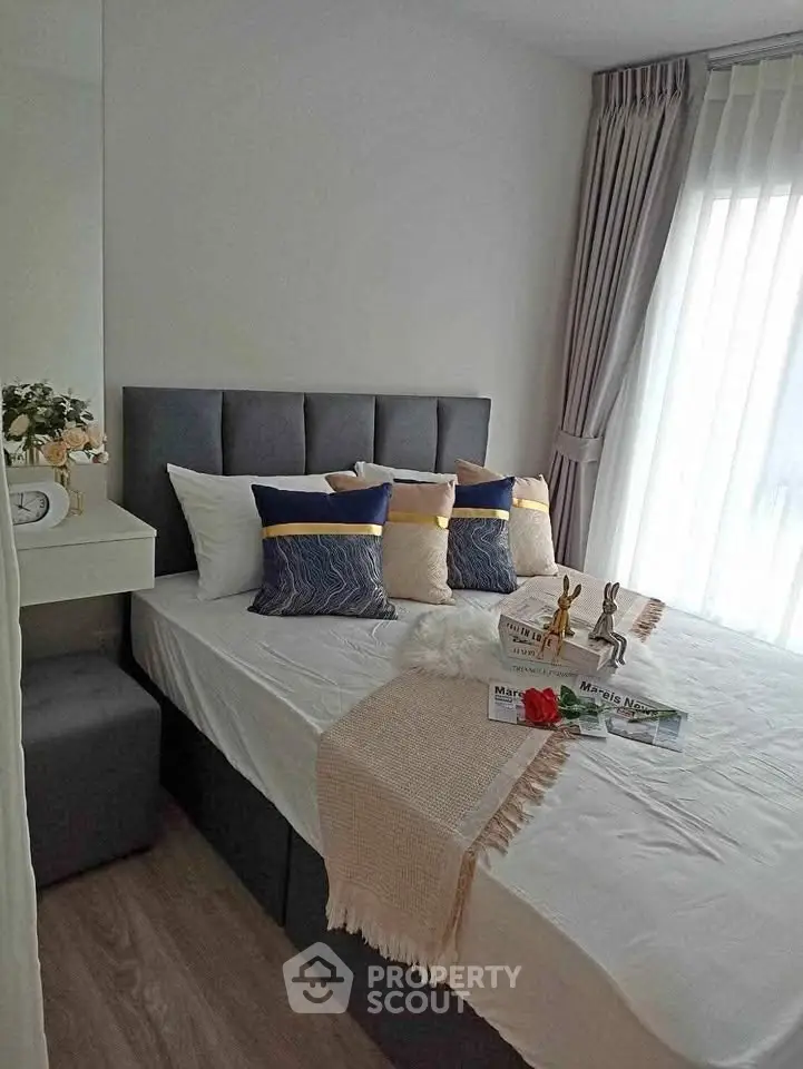 Cozy bedroom with stylish decor and natural light, perfect for relaxation and comfort.