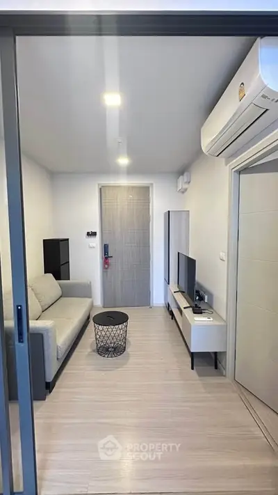 Modern living room with sleek furniture and air conditioning