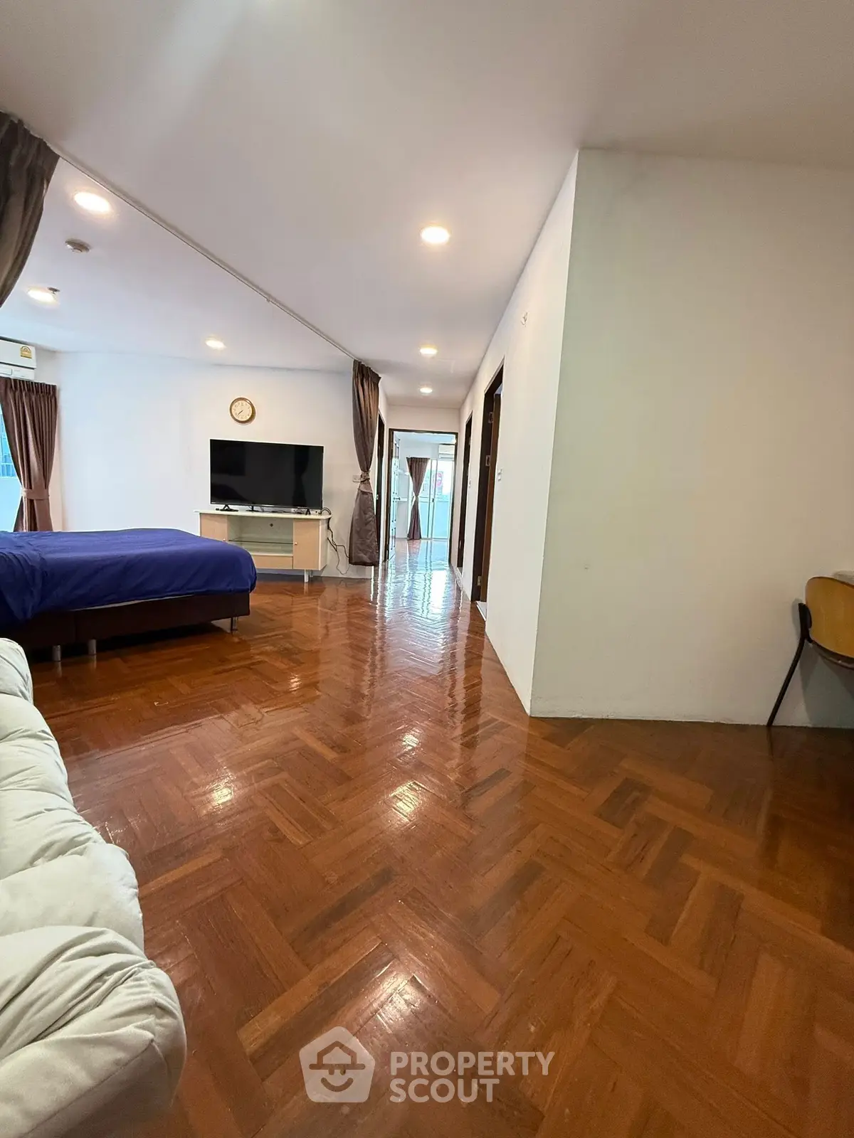 Spacious open-plan living area with wooden flooring and modern decor