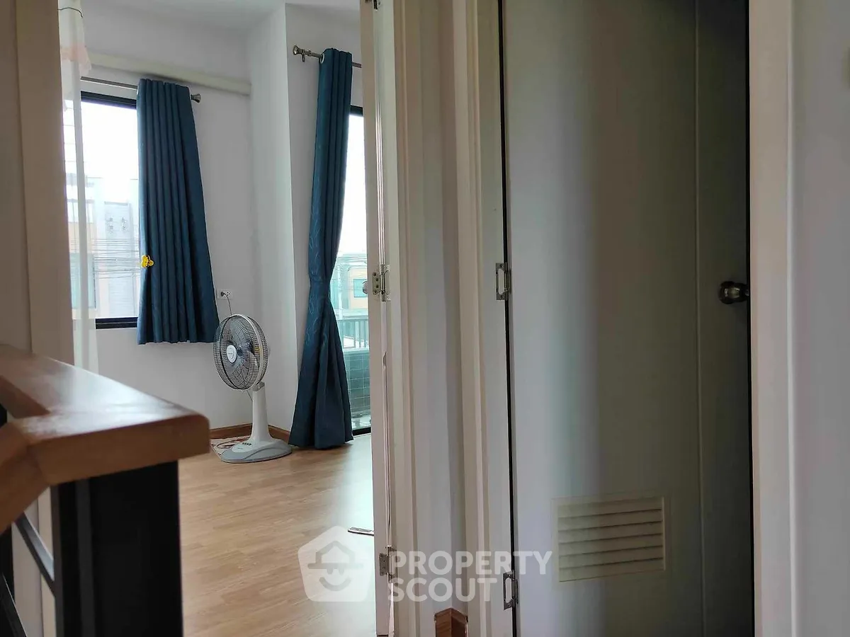 Bright and airy corner unit with a spacious living room leading to a large balcony, featuring modern flooring and elegant curtains.