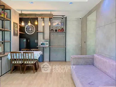 Modern living room with stylish decor and dining area, featuring a cozy sofa and elegant lighting.