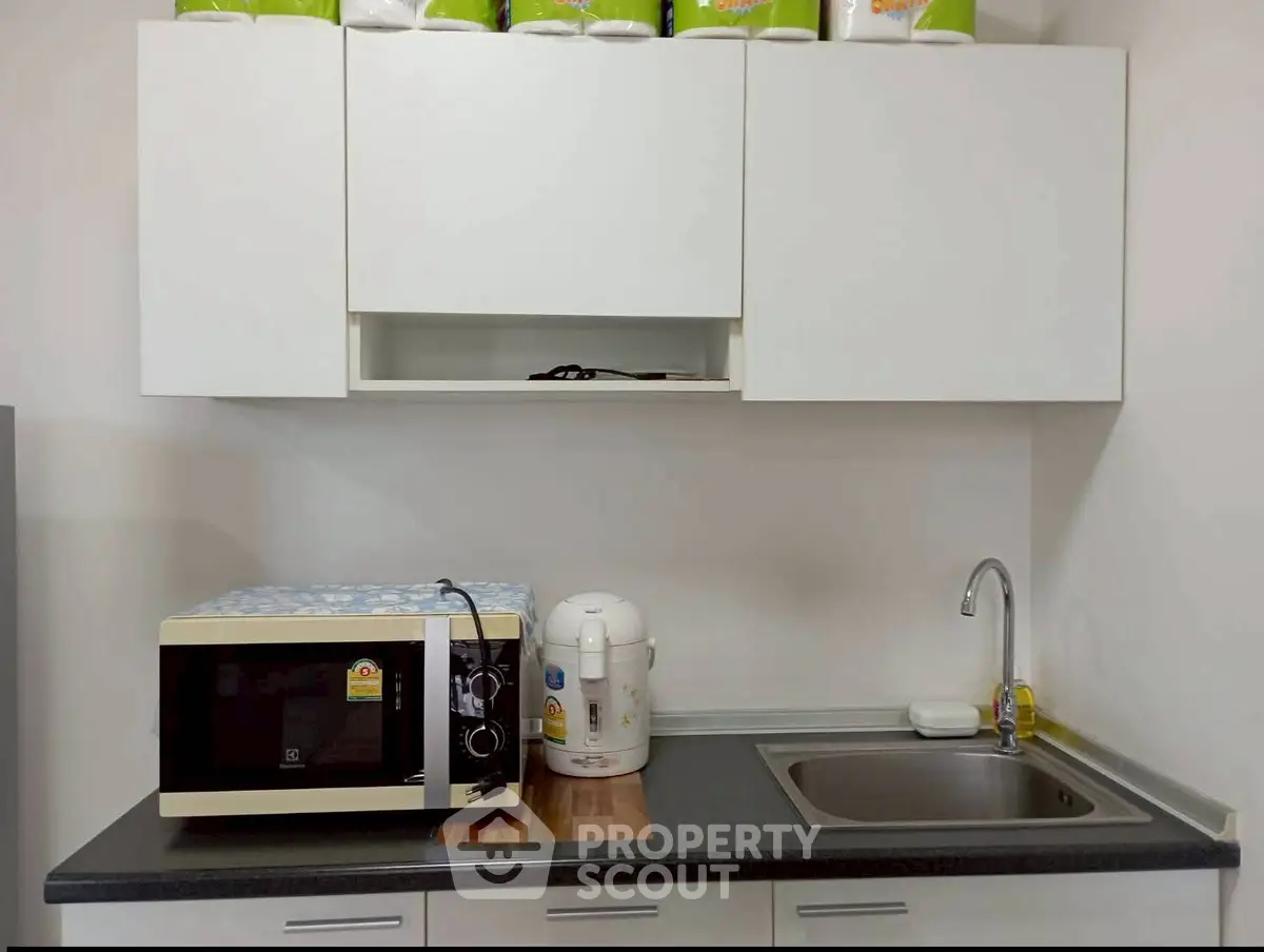 Modern kitchen with sleek white cabinets and appliances