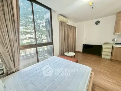 Bright bedroom with large window and modern furnishings