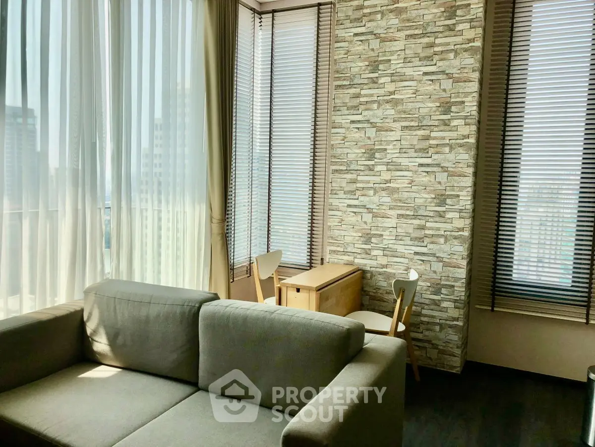 Modern living room with stone accent wall and panoramic city view
